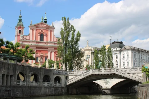 Le Triple Pont piétonnier de Ljubljana traversant la rivière ensoleillée.